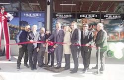 Nassry Mujalli, Councilmember Jimmy Van Bramer, Urban Market owner Sam Mujalli, Key Food Vice President of Business Development John Durante, Queens Borough President Melinda Katz, state Senator Michael Gianaris, and CEO Dean Janeway, and Vice President of Strategic Planning Chet Koby get ready to cut the ribbon at the Urban Market grand opening celebration. 