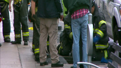 Firefighters on the scene after a man fell into a grating in Long Island City on June 2, 2015. (credit: CBS2) 